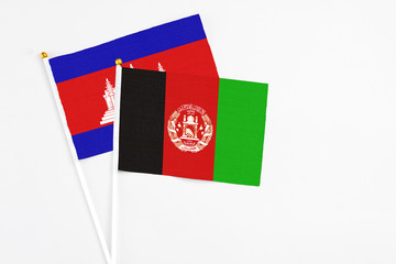 Afghanistan and Cambodia stick flags on white background. High quality fabric, miniature national...