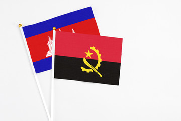 Angola and Cambodia stick flags on white background. High quality fabric, miniature national flag....