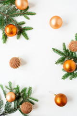 Christmas / New Year holiday composition. Frame of Christmas baubles / balls and fir branches on white background. Flat lay, top view festive concept.