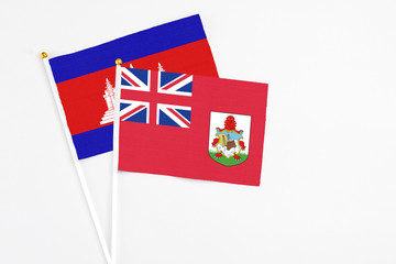 Bermuda and Cambodia stick flags on white background. High quality fabric, miniature national flag....