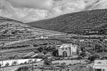  empty mysterious mountainous landscape from the center of the Canary Island Spanish Fuerteventura with a cloudy sky