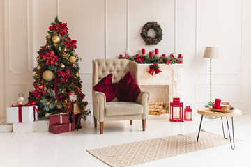 Christmas interior with christmas tree and a fireplace in traditional red color. Beautiful christmas decor. Happy new year concept.