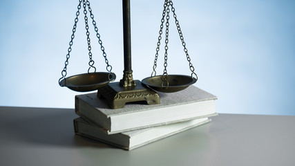 Law scales on wooden desk concept for justice and equality