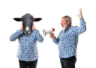 Portrait of senior man arguing with himself as a donkey on white studio background. Concept of...