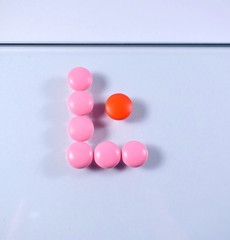 pink and red pills are in the form of the letter L