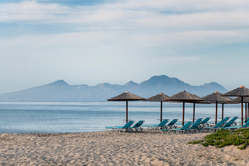 Umbrellas on Kardamena city beach in Kos island, Greece.