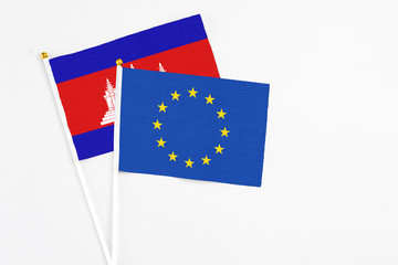 European Union and Cambodia stick flags on white background. High quality fabric, miniature...