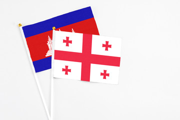 Georgia and Cambodia stick flags on white background. High quality fabric, miniature national flag....