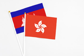 Hong Kong and Cambodia stick flags on white background. High quality fabric, miniature national flag. Peaceful global concept.White floor for copy space.