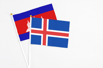 Iceland and Cambodia stick flags on white background. High quality fabric, miniature national flag. Peaceful global concept.White floor for copy space.