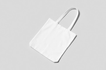 White tote bag mockup on a grey background.
