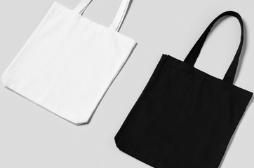 Fototapeta White and black tote bags mockup on a grey background. obraz