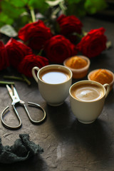 Fototapeta na wymiar coffee cup, bouquet red roses (gift, date or congratulation) concept. food background. copy space. Top view