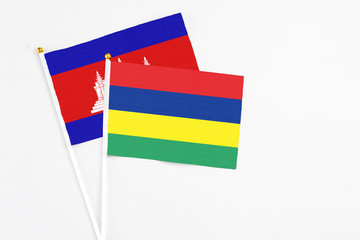 Mauritius and Cambodia stick flags on white background. High quality fabric, miniature national...