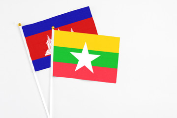 Myanmar and Cambodia stick flags on white background. High quality fabric, miniature national flag. Peaceful global concept.White floor for copy space.