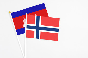 Norway and Cambodia stick flags on white background. High quality fabric, miniature national flag....