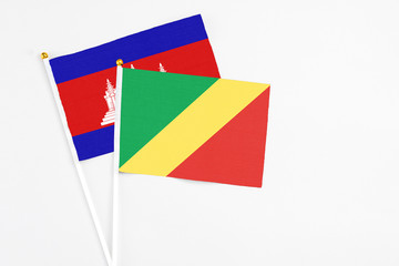 Republic Of The Congo and Cambodia stick flags on white background. High quality fabric, miniature national flag. Peaceful global concept.White floor for copy space.
