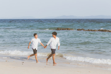 Fototapeta na wymiar Homosexual portrait young asian couple running with cheerful together on beach in summer, asia gay going tourism for leisure and relax with happiness in vacation at sea, LGBT legal concept.