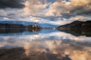 Amazing colorful view of Bled lake with St. Marys Church of the Assumption on the small island and mountains in the background at sunset