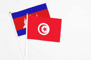 Tunisia and Cambodia stick flags on white background. High quality fabric, miniature national flag....