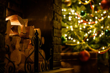 Fototapeta na wymiar Christmas and New Year interior - blur background: fireplace, lamps, green Christmas tree, brown leather sofa, gifts, candles, moose rocking chair. Lots of lights glowing in the dark.