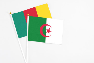 Algeria and Cameroon stick flags on white background. High quality fabric, miniature national flag....