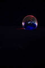 Christmas ball on a black background, planet in space