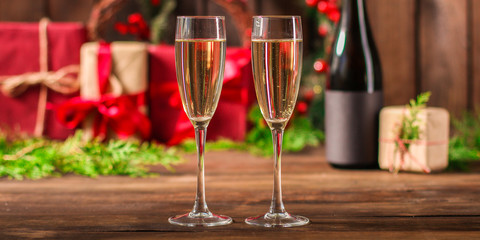 champagne in transparent glasses and a bottle, happy holidays! gifts and holiday, happy New Year, Christmas. festive food background. top view. copy space