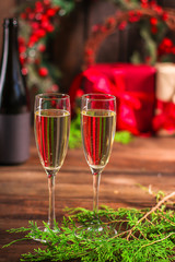 champagne in transparent glasses and a bottle, happy holidays! gifts and holiday, happy New Year, Christmas. festive food background. top view. copy space