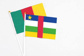 Central African Republic and Cameroon stick flags on white background. High quality fabric, miniature national flag. Peaceful global concept.White floor for copy space.