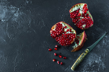  ripe red pomegranate on and grain on a gray background