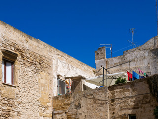 Fototapeta na wymiar Houses in picturesque old town of Gallipoli, a beautiful travel destination in Puglia, Italy