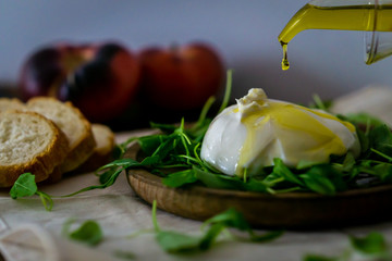 Burrata with arugula, bread and olive oil