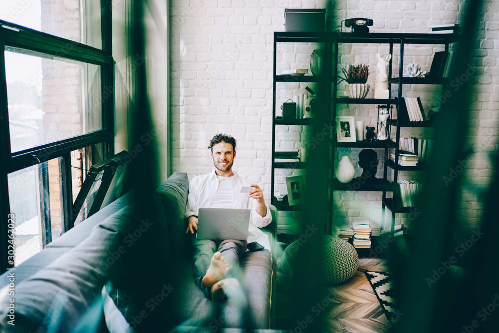 Aufkleber cheerful caucasian millennial man satisfied with internet banking app on laptop computer paying via 