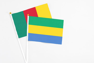 Gabon and Cameroon stick flags on white background. High quality fabric, miniature national flag....
