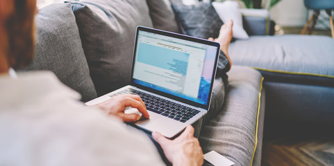 Cropped image of man searching information and browse web page during free time at home with...