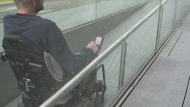 4k resolution follow of a man on electric wheelchair using a ramp. Accessibility concept
