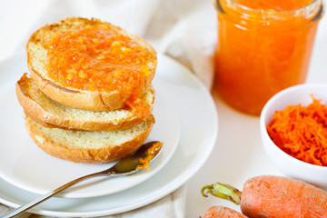 Vegetarian organic sweet carrot jam or marmalade toast topping for breakfast close-up.Healthy vegetable dessert on white background.Horizontal orientation