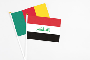 Iraq and Cameroon stick flags on white background. High quality fabric, miniature national flag. Peaceful global concept.White floor for copy space.