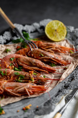 fried king prawns with lemon grilled, a small depth of field. food composition on a gray background.