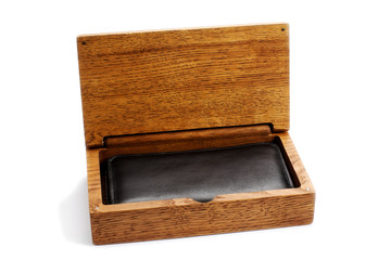 Open wooden box with a wallet on a white background.