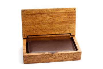 Open wooden box with a wallet on a white background.