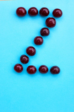 Letter Z fresh cherry alphabet blue color flat lay