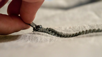 a zipper unfastens close up
