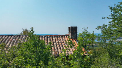 Fototapeta na wymiar house roof with a chimney on a background of blue sky