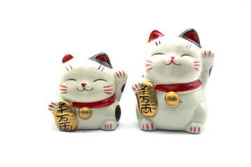 ceramic lucky cat statue for Japanese isolated on a white background, Holds a gold medal in Japanese that translates into prosperity and good fortune.