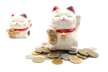 ceramic lucky cat statue for Japanese isolated on a white background, Holds a gold medal in Japanese that translates into prosperity and good fortune.