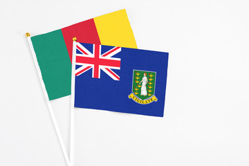 Fototapeta premium British Virgin Islands and Cameroon stick flags on white background. High quality fabric, miniature national flag. Peaceful global concept.White floor for copy space.