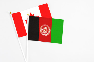 Afghanistan Afghanistan and Canada stick flags on white background. High quality fabric, miniature...