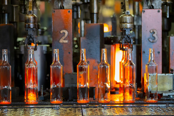 Glassworks. Glass industry. The process of making glass bottles.